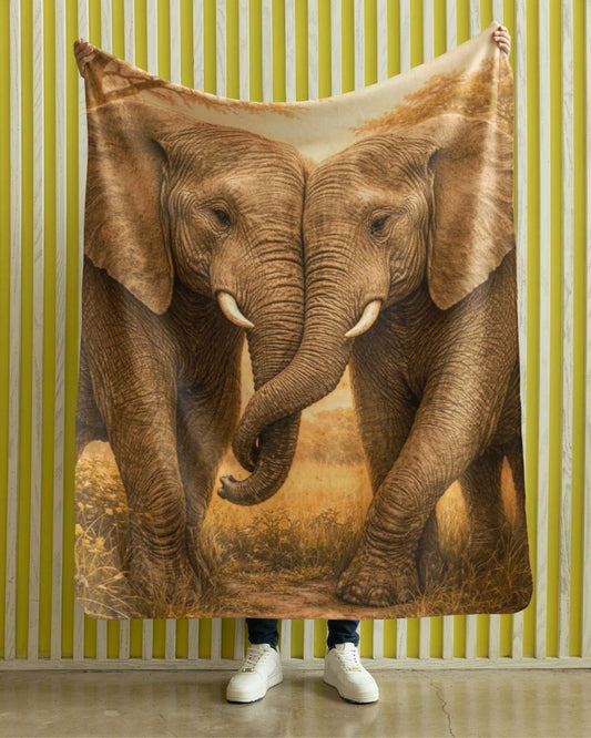 Velveteen blanket featuring two elephants standing together with intertwined trunks in warm natural tones