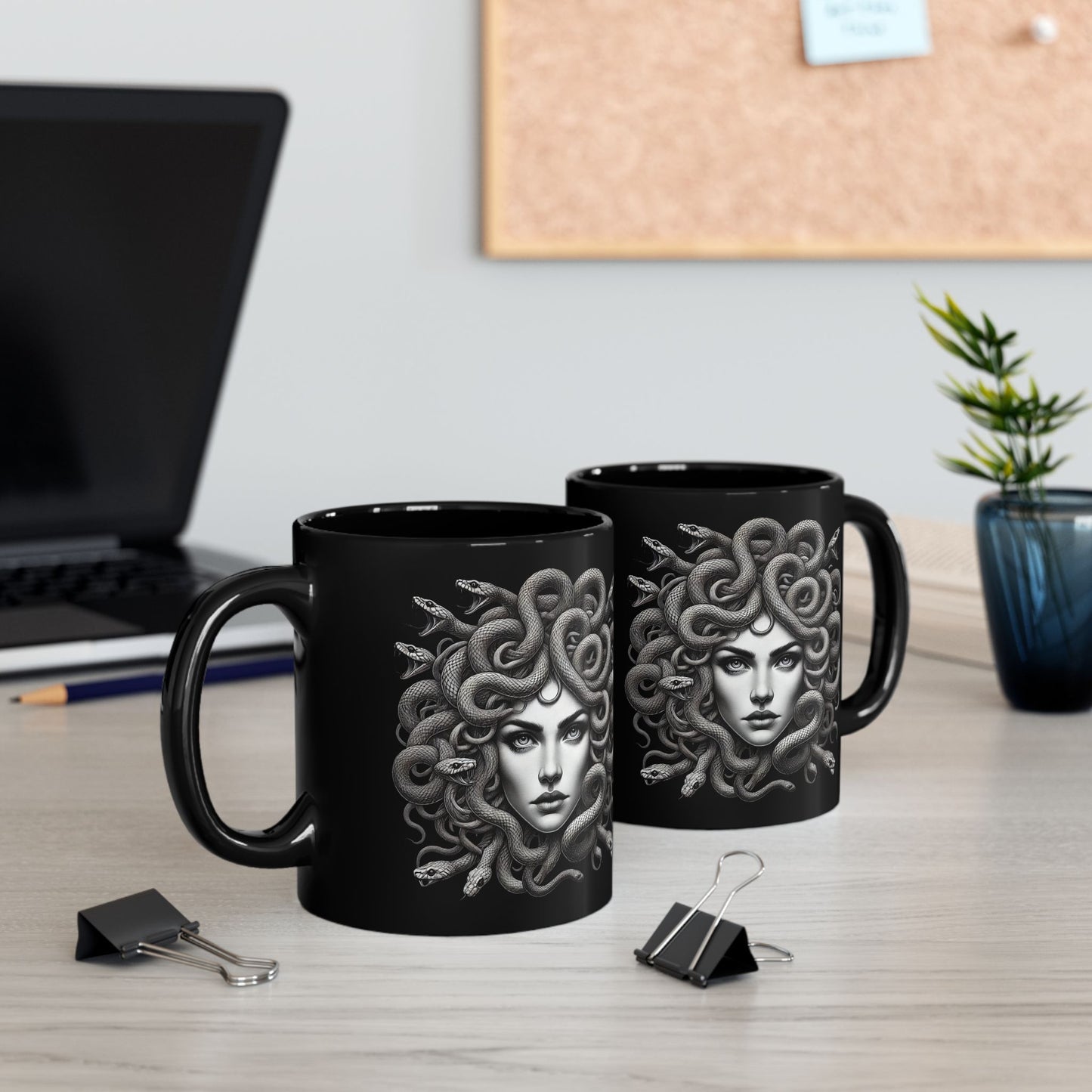 Black ceramic mug featuring a detailed grayscale illustration of Medusa with snakes for hair.