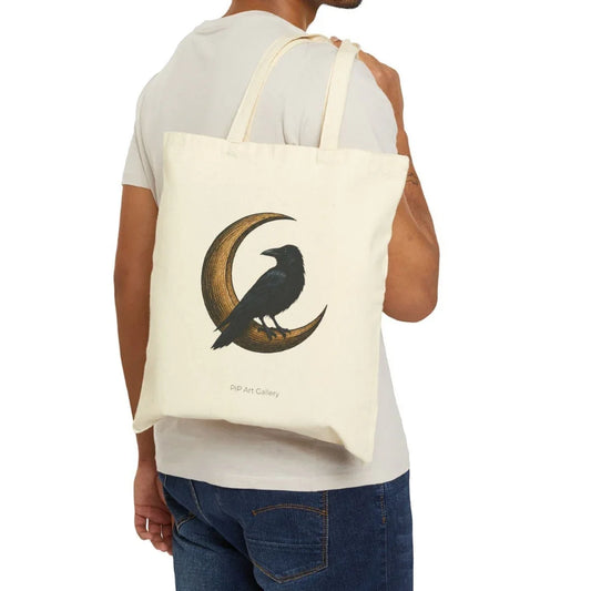 Cream tote bag with a black raven on a golden crescent moon illustration