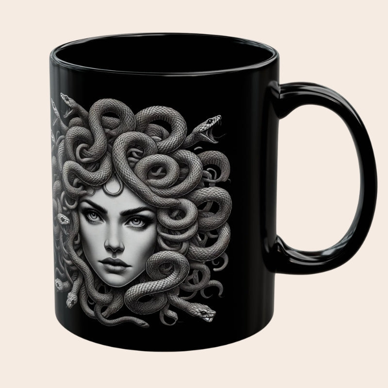 Black ceramic mug featuring a detailed grayscale illustration of Medusa with snakes for hair.