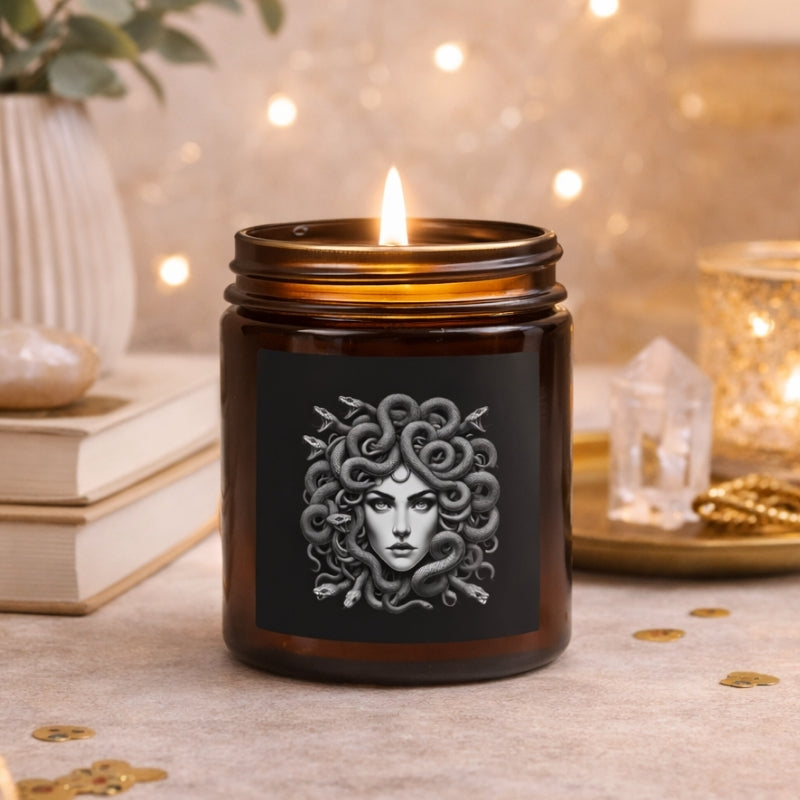 Medusa candle in amber glass jar with soft warm lighting, styled on a neutral home decor