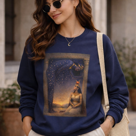 Woman wearing navy sweatshirt with Egyptian mythology-inspired goddess and starry sky art print