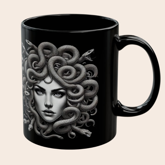 Black ceramic mug featuring a detailed grayscale illustration of Medusa with snakes for hair.