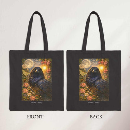 Black tote bag with mystical raven, moon, flowers, and glowing sun artwork on both sides
